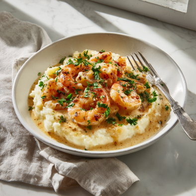 Plate of garlic shrimp with mashed potatoes and parsley