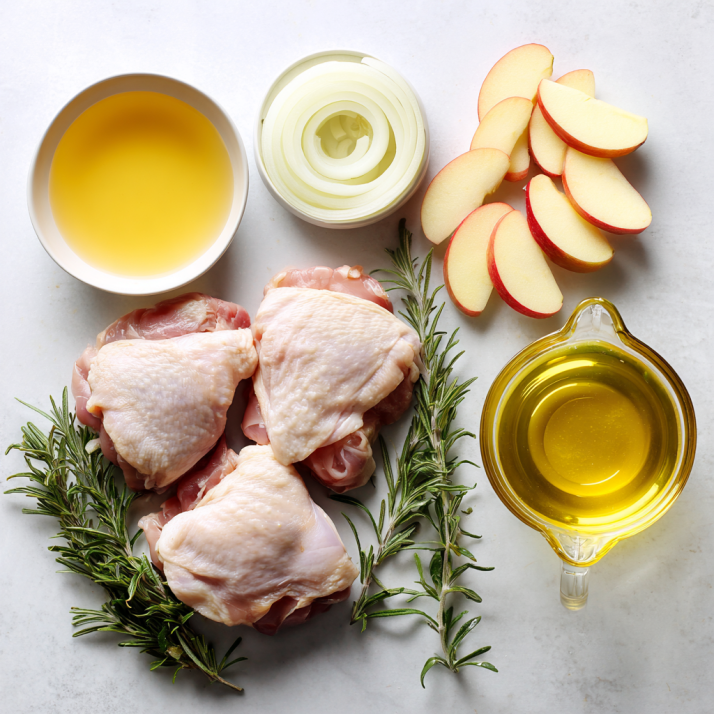Amazing Rosemary Apple Cider Chicken 5 Fresh ingredients for rosemary apple cider chicken laid out on a countertop
