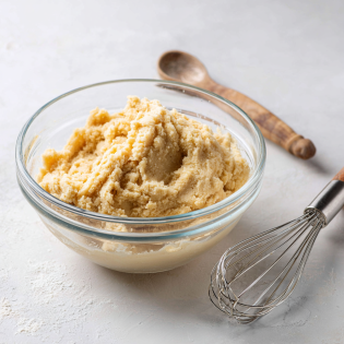 Creamy browned butter cookie dough being mixed in a bowl